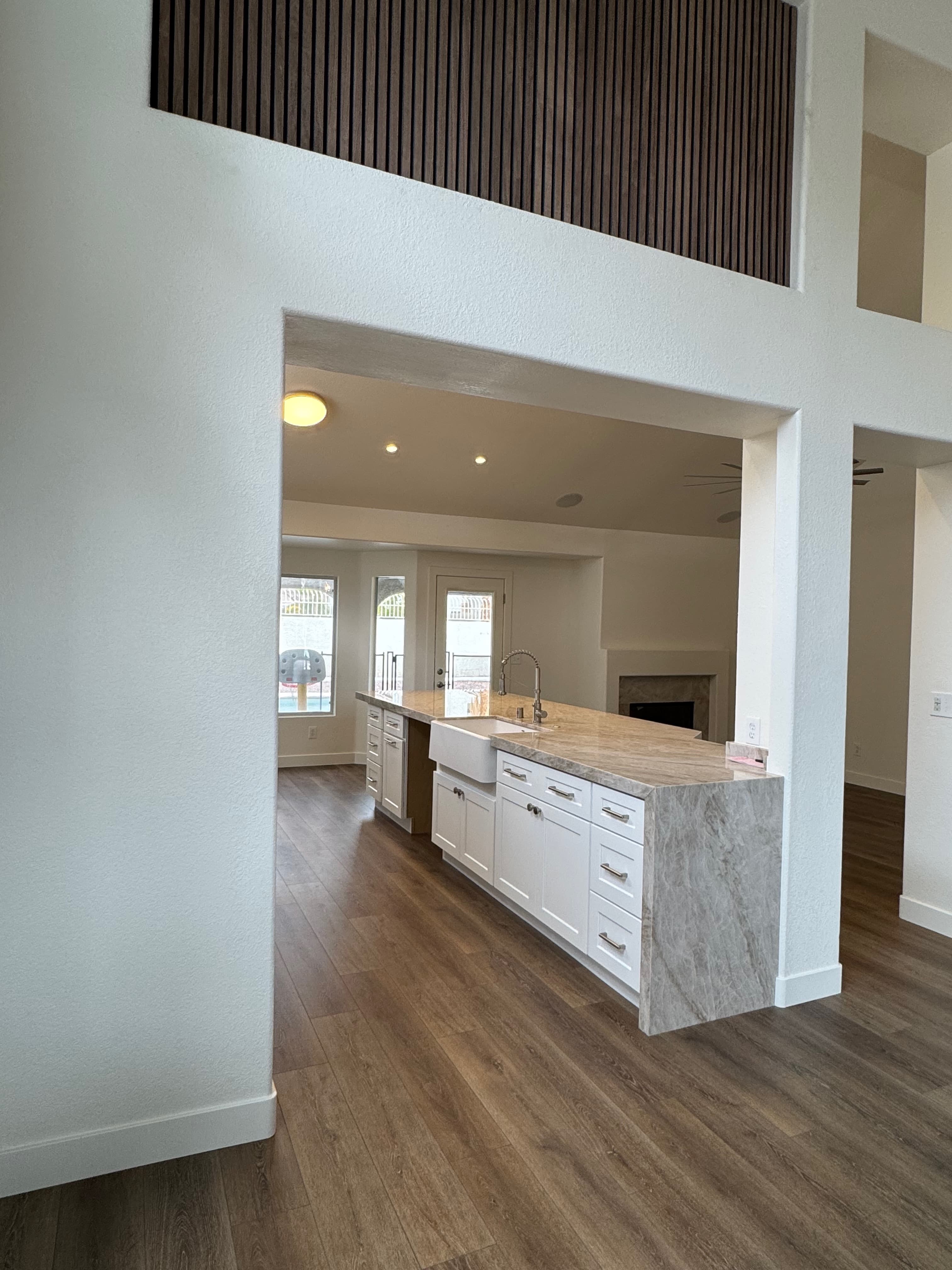 View from entry — farmhouse sink, open to living room