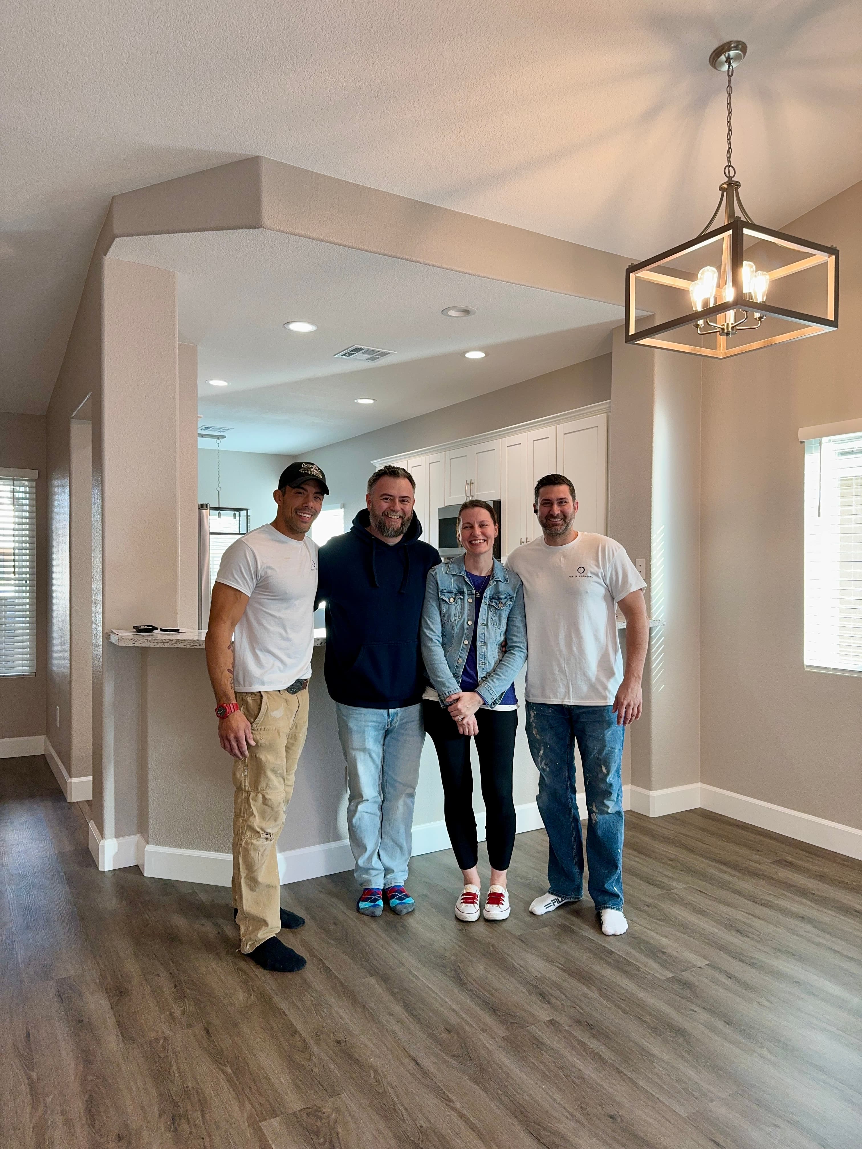 John and Joe with happy clients in their finished remodel